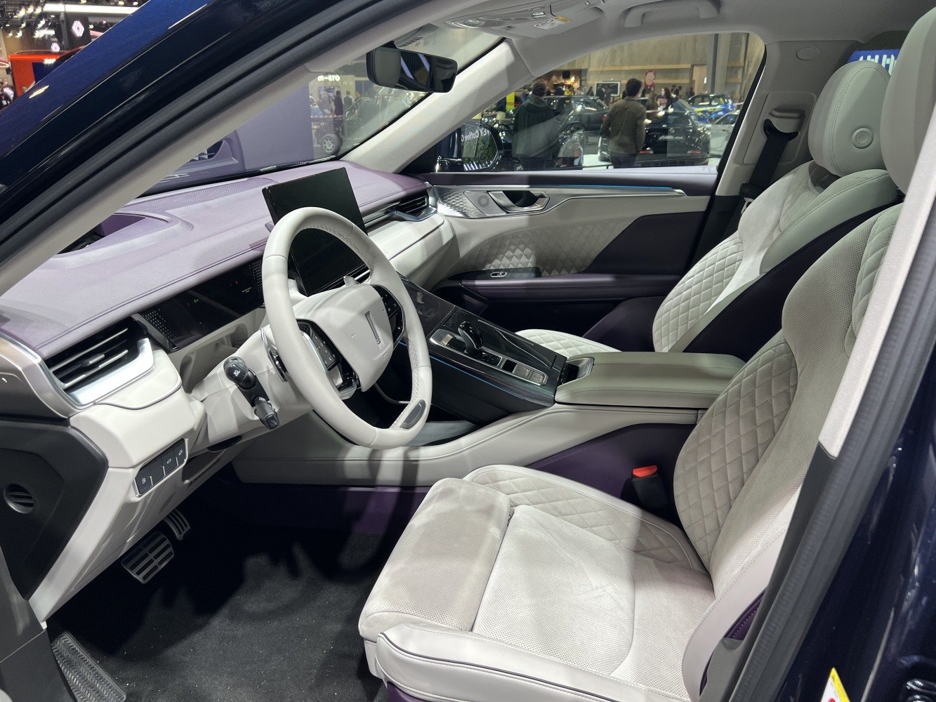 Beige quilted leather seats and modern digital dashboard interior