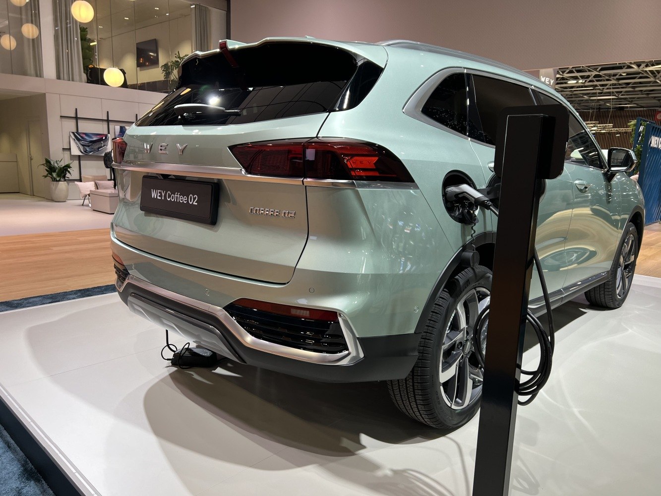 Rear an electric SUV with LED taillights connected to a charging station
