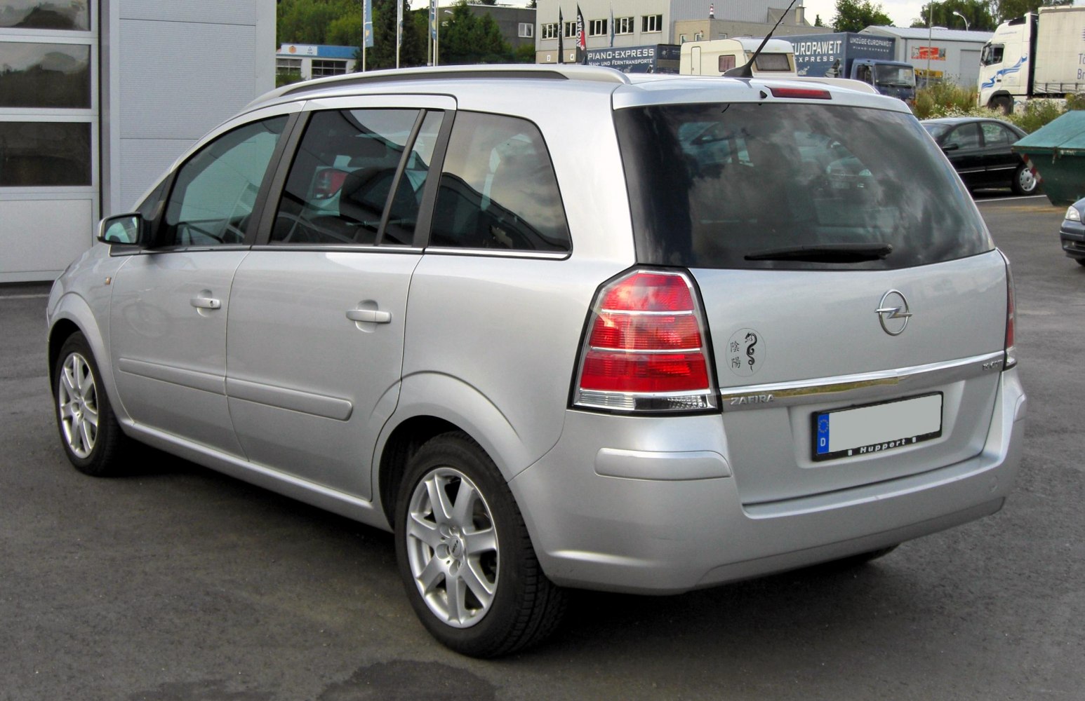 Silver MPV rear and side view with distinctive taillights and alloy wheels