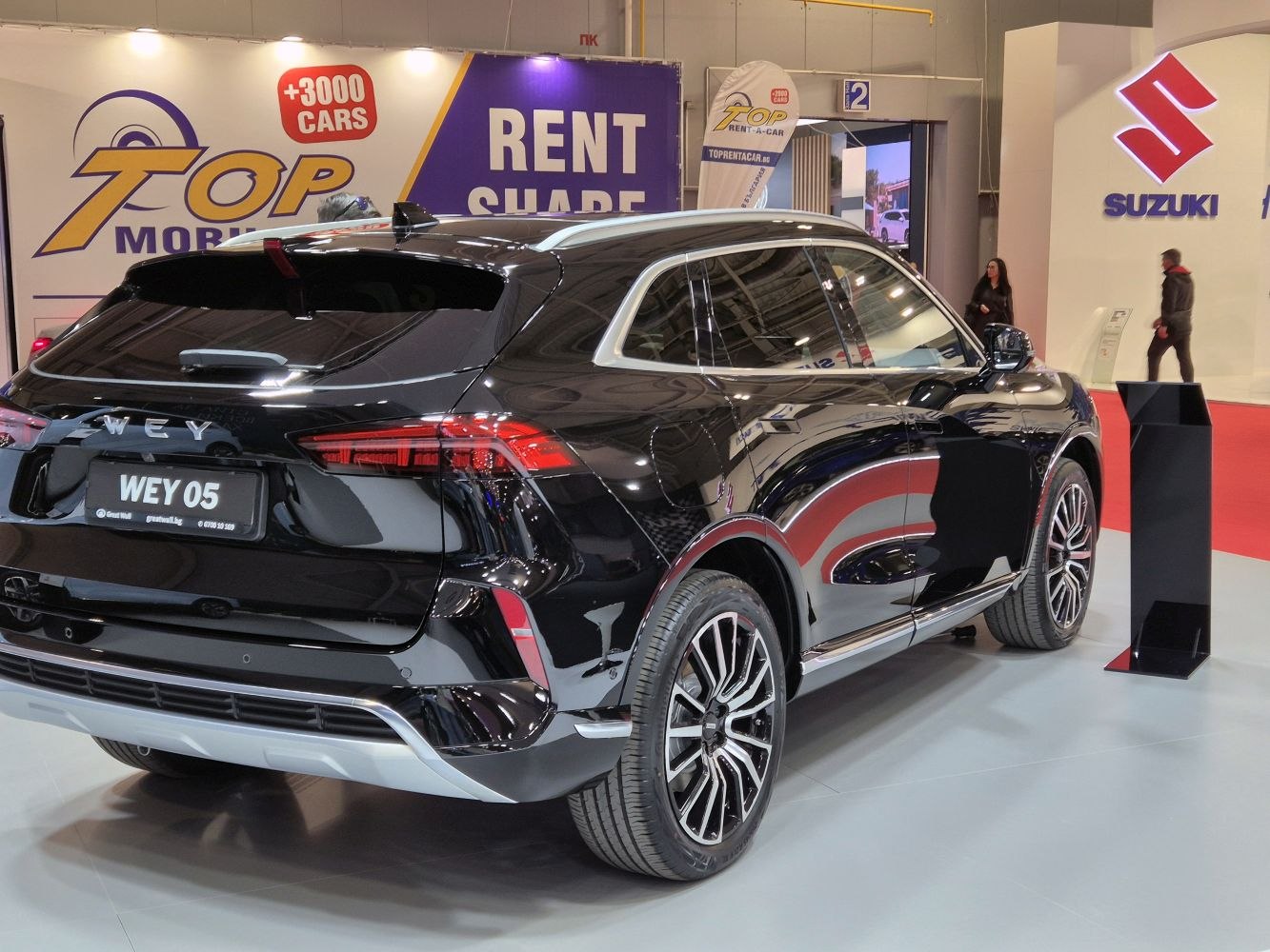 Glossy black SUV rear side with LED lights and alloy wheels