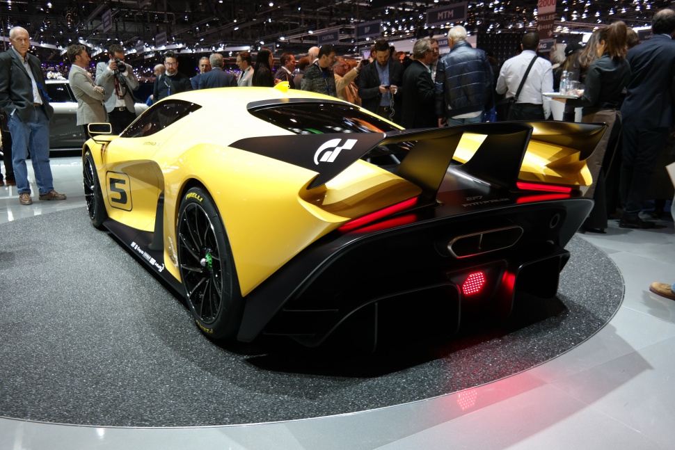 Sleek yellow sports car rear with large wing and diffuser