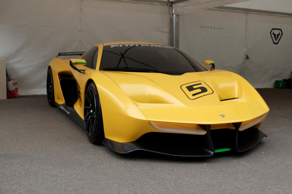 Yellow sports car with aerodynamic front and black splitter