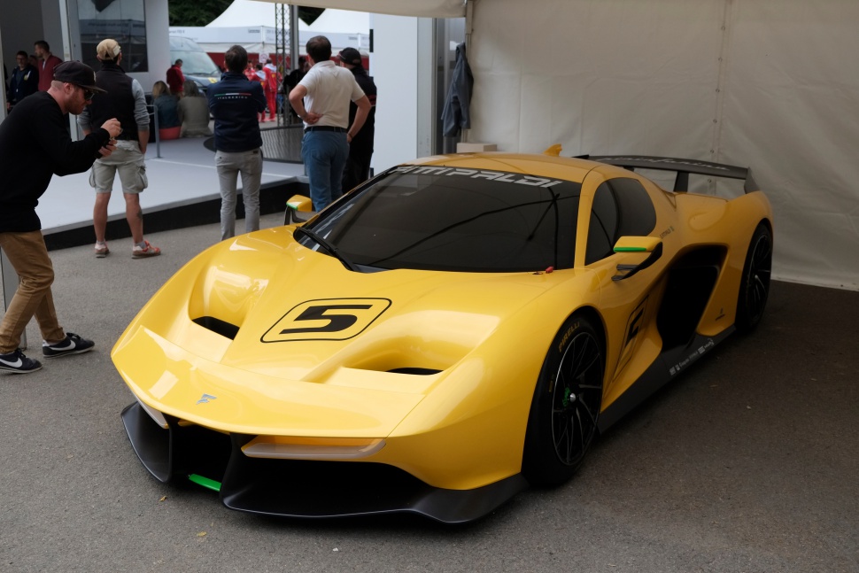 Yellow hypercar front with sculpted hood and black wheels