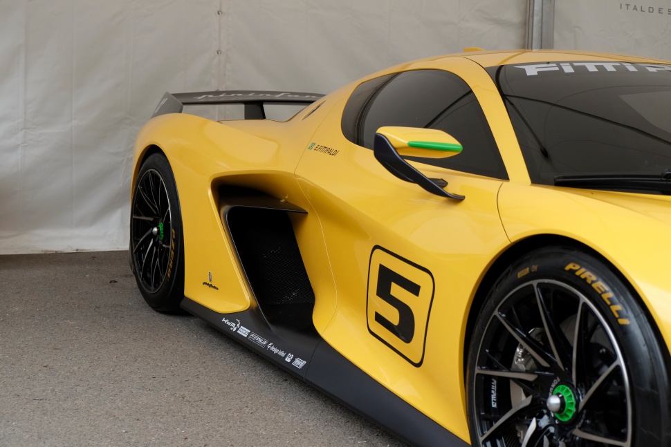 Yellow sports car side with aerodynamic air intakes and racing decals