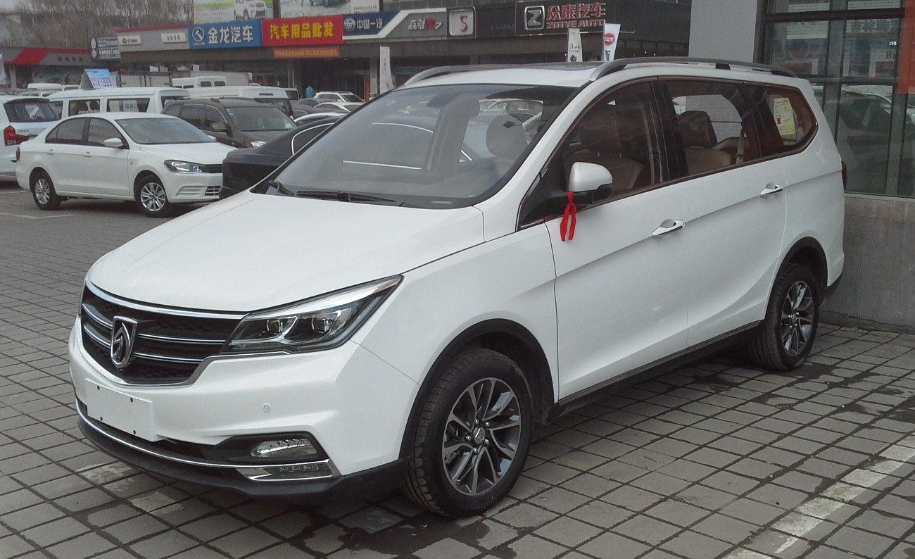 White MPV front side with sleek headlights and grille