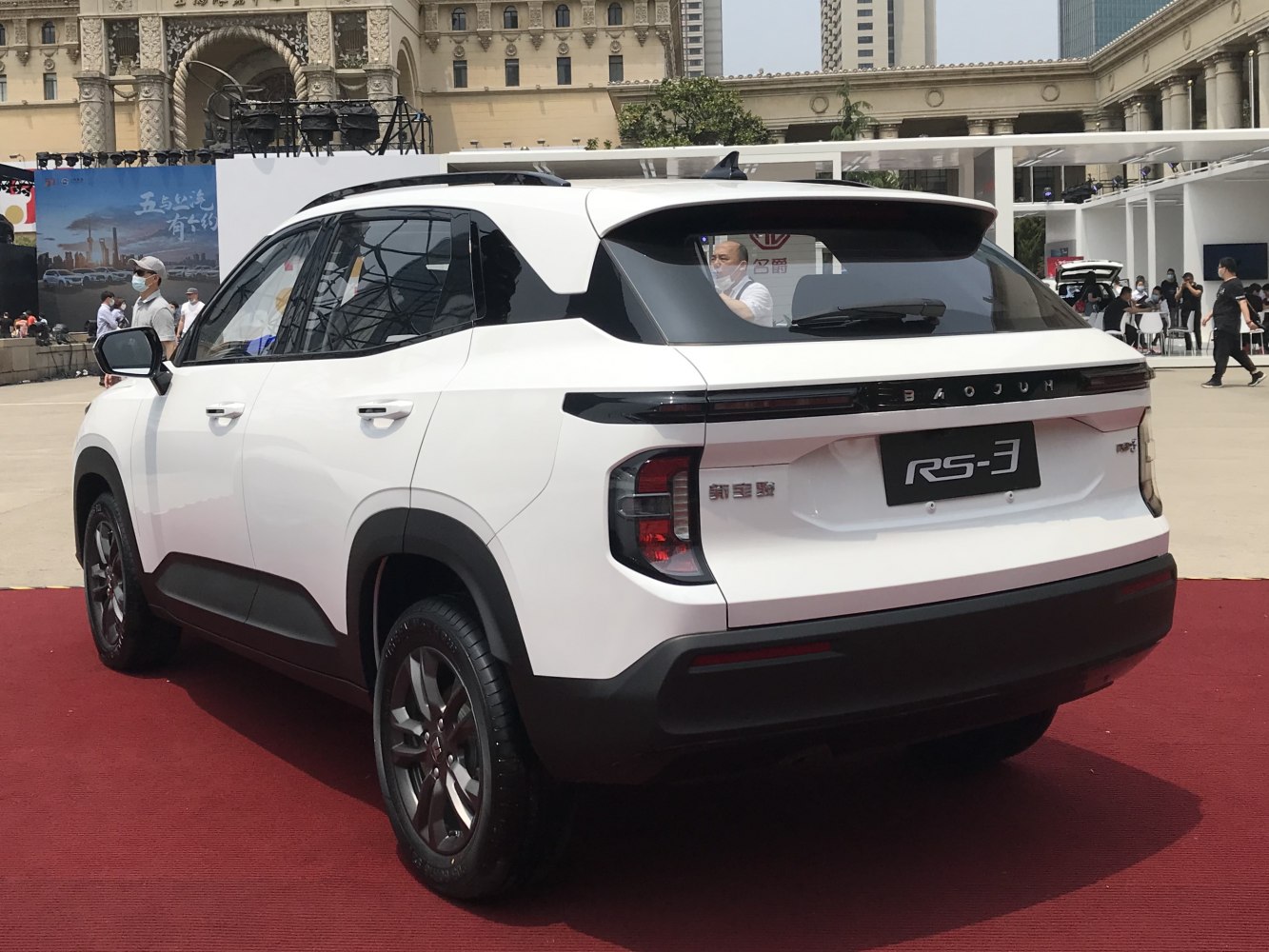 Rear view of compact SUV with sleek taillights and roof spoiler