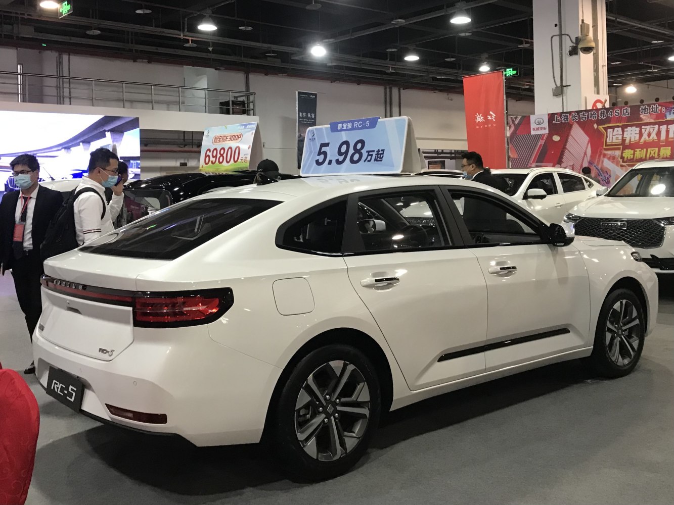 Modern white sedan rear-side with connected taillights and smooth body lines