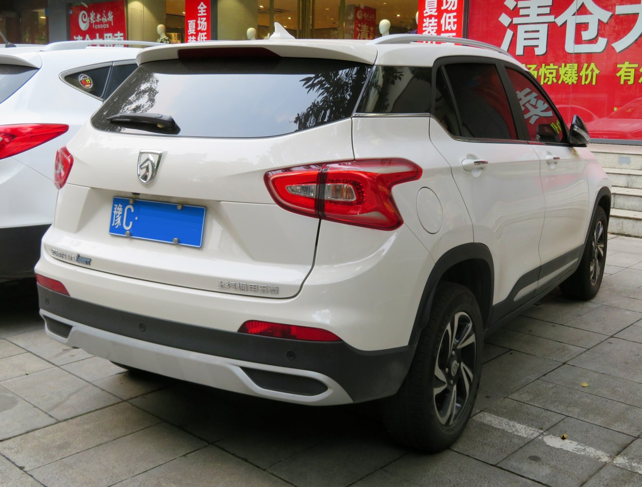 Rear view of SUV with distinctive tail lights and tinted rear window.