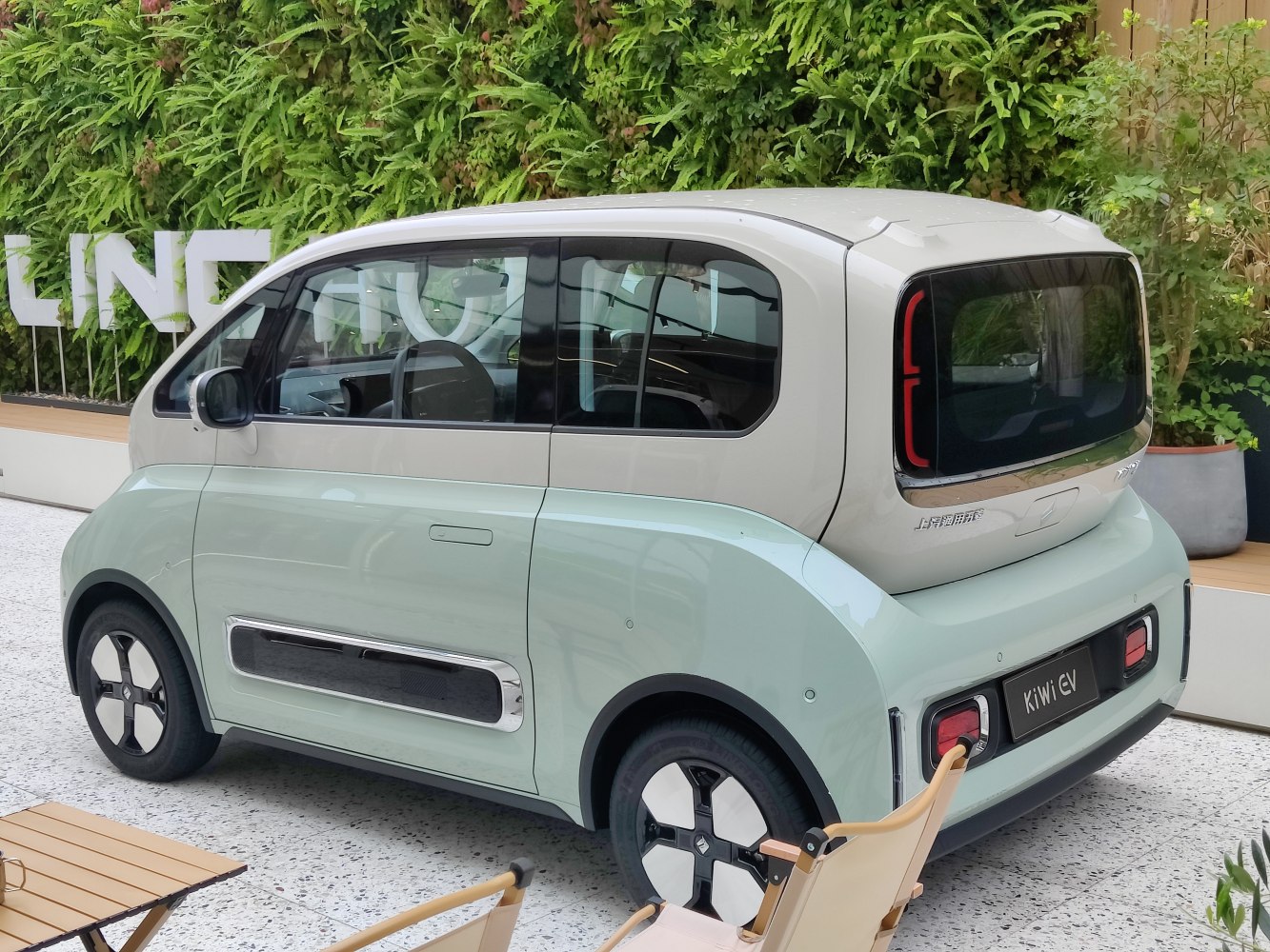 Compact compact EV rear side profile with unique rear window and lighting