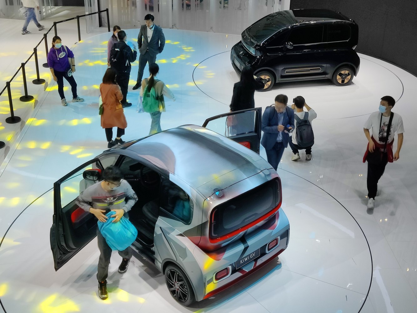 Compact electric city cars with unique design and open doors for user interaction