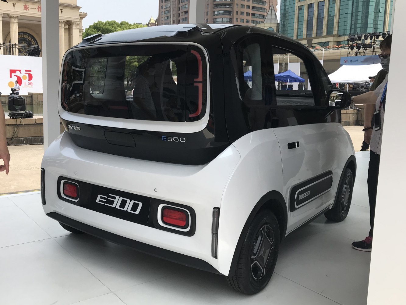 Rear view of compact electric microcar with large rear window and boxy shape