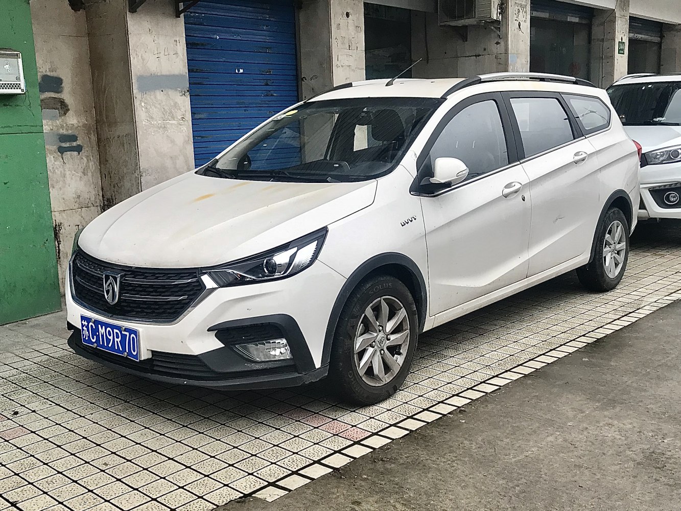 White compact 5-door hatchback with sleek headlights and roof rails
