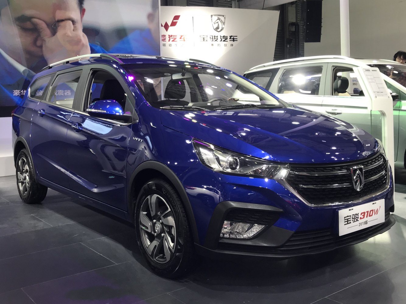 Blue compact wagon SUV with modern front grille and alloy wheels