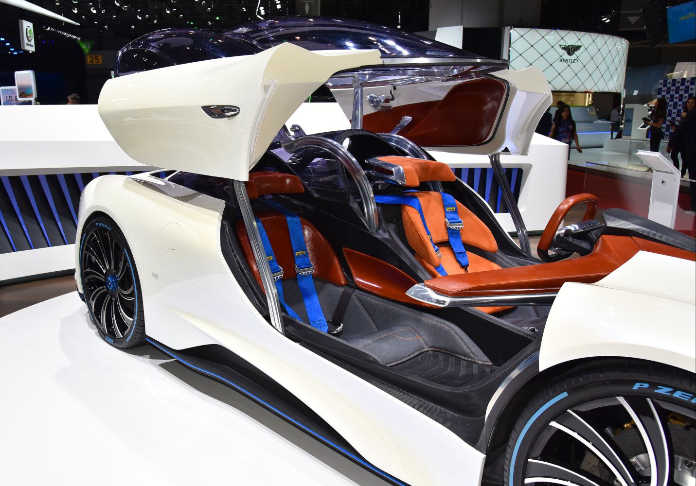 Gullwing doors and sporty dual racing seats with blue harnesses