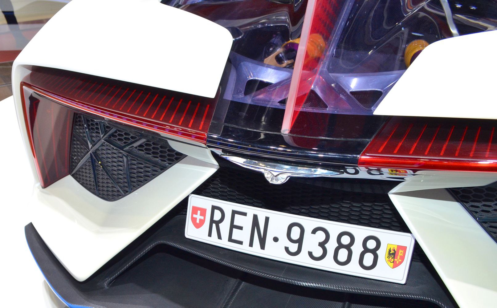 Close-up of rear light and aerodynamic design with hex mesh grille and diffuser