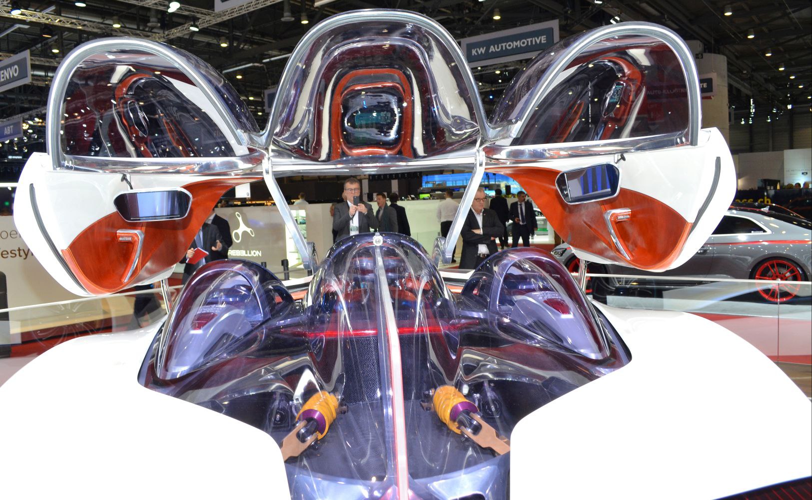 Canopy-style doors with transparent futuristic cockpit and visible suspension components