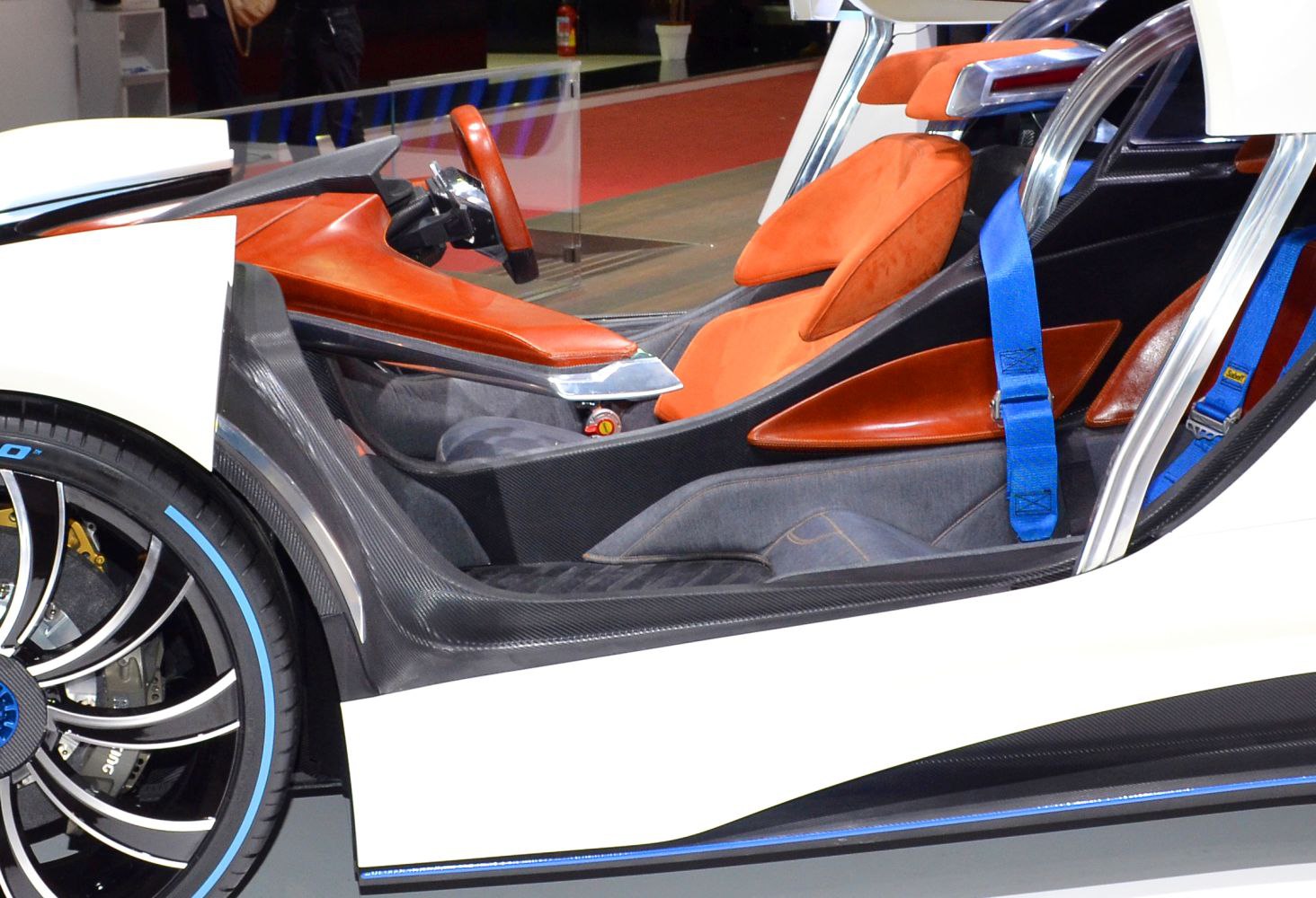 Sporty car interior with orange seats and detailed wheel with blue accents