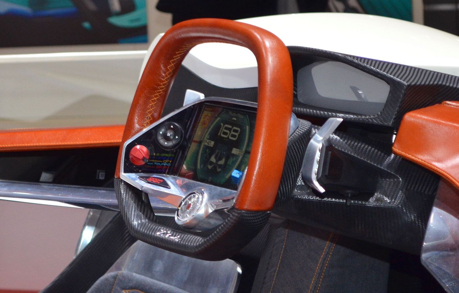 Futuristic steering wheel with integrated digital dashboard display.