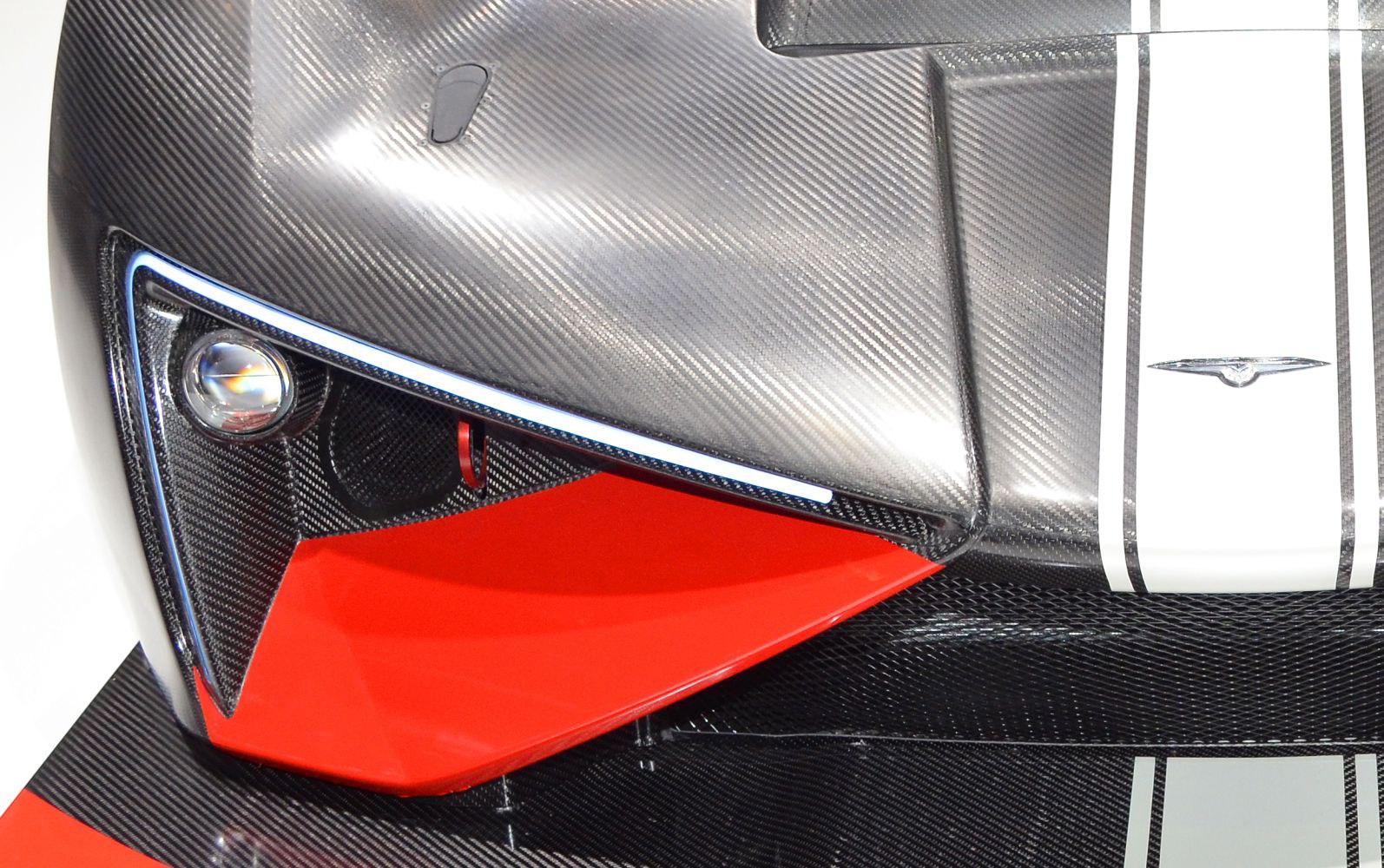 Front close-up showing carbon fiber bodywork and red aerodynamic intake vent