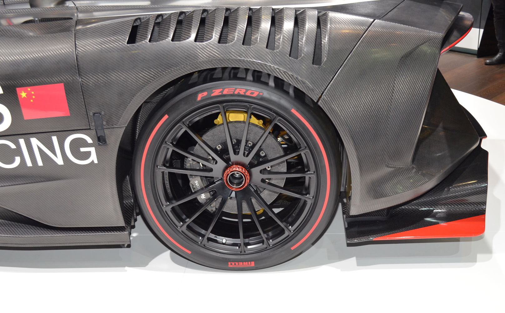 Carbon fiber body and aerodynamic vents around rear racing wheel with Pirelli P Zero tire