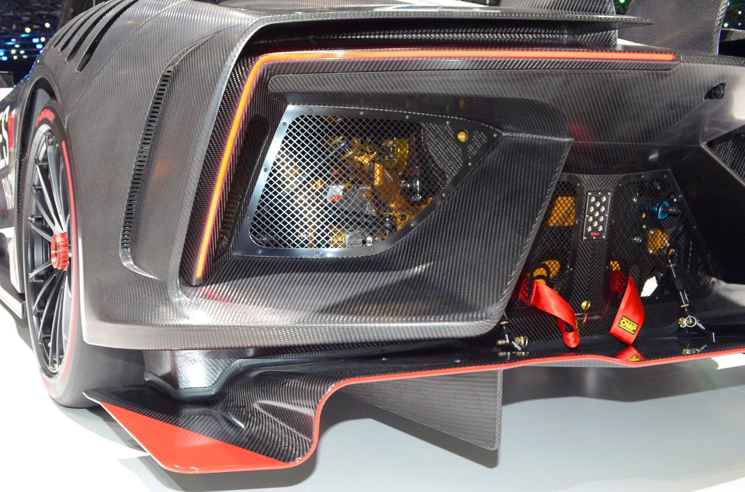 Carbon fiber rear diffuser, brake cooling vents, and red racing harness