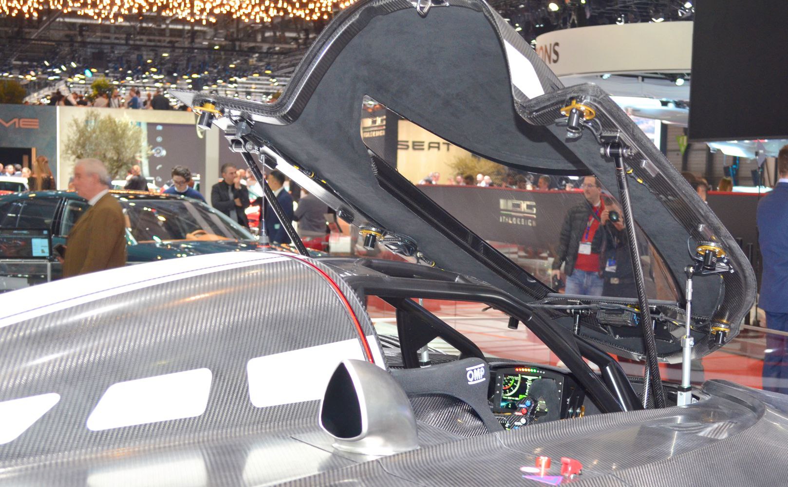 Open carbon fiber rear hatch and visible cockpit dashboard