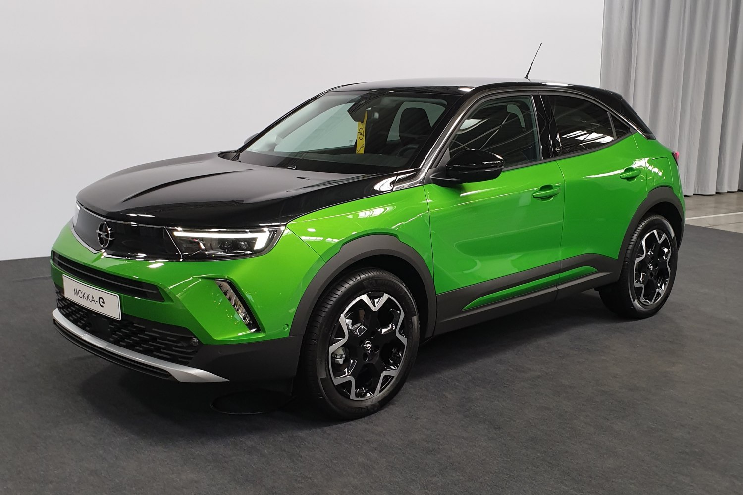 Electric crossover with two-tone green and black body and LED headlights