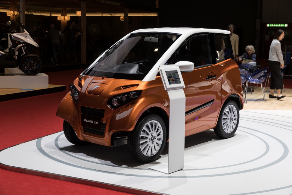 Compact electric mini vehicle with futuristic design and urban focus