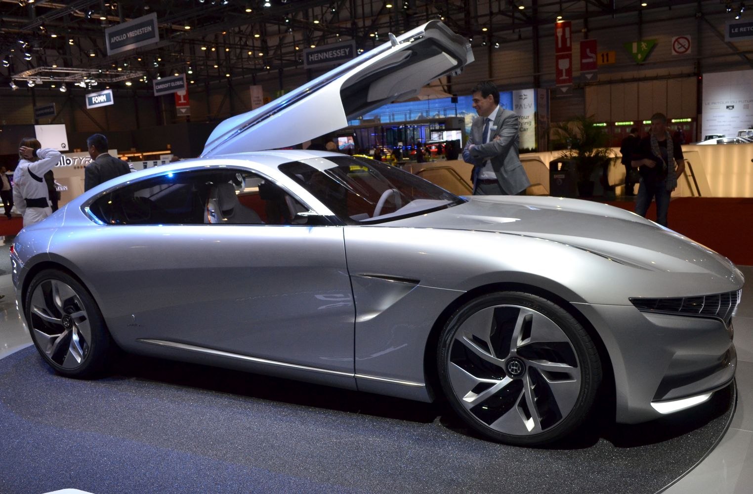 Sleek silver coupe with gullwing doors and aerodynamic design