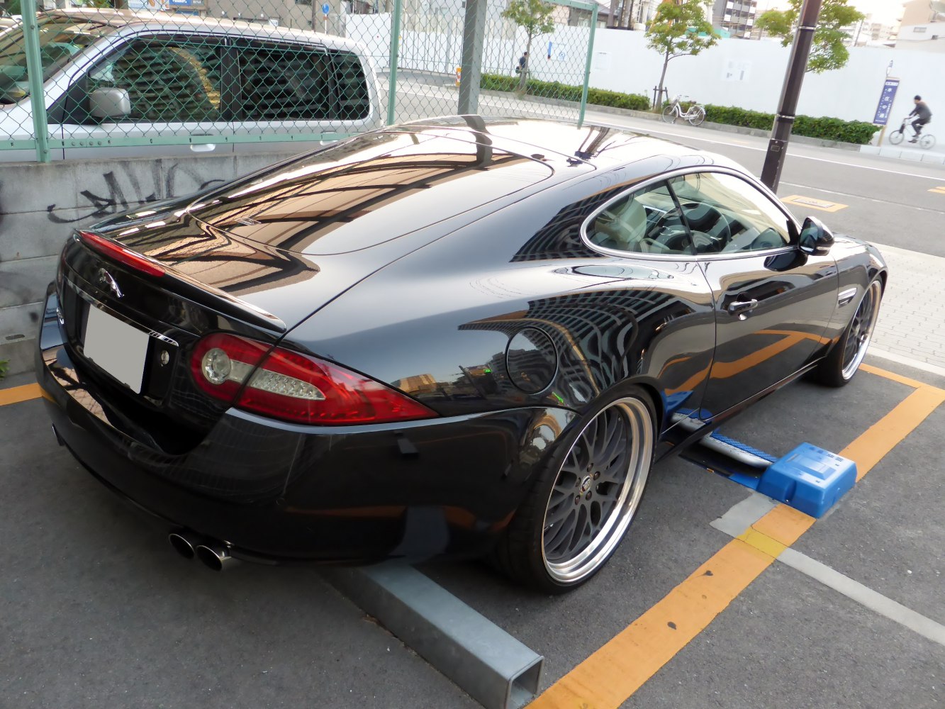 Rear view of sleek coupe with custom multi-spoke wheels and distinct taillights