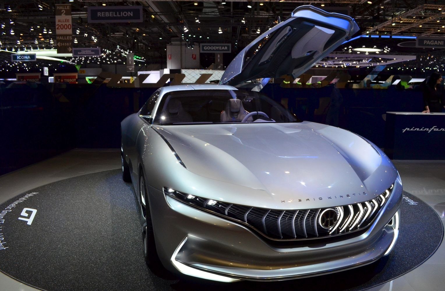 Sleek silver car front with aerodynamic design and open gullwing door