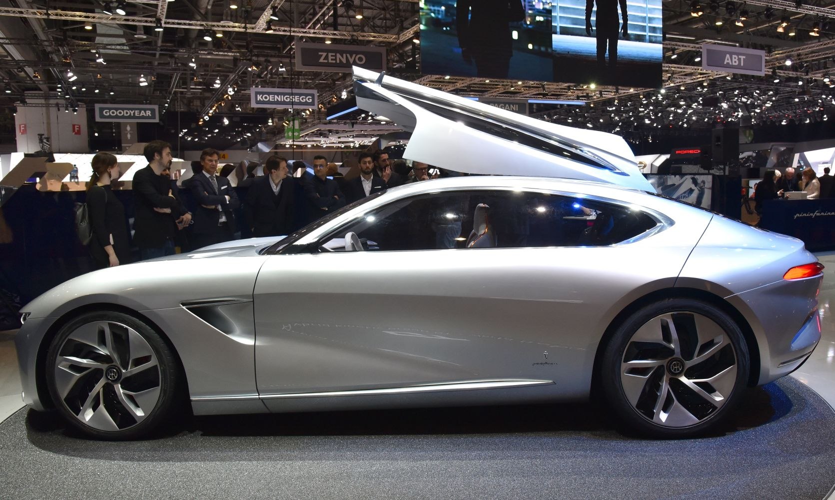 Sleek silver coupe with gullwing doors and aerodynamic design