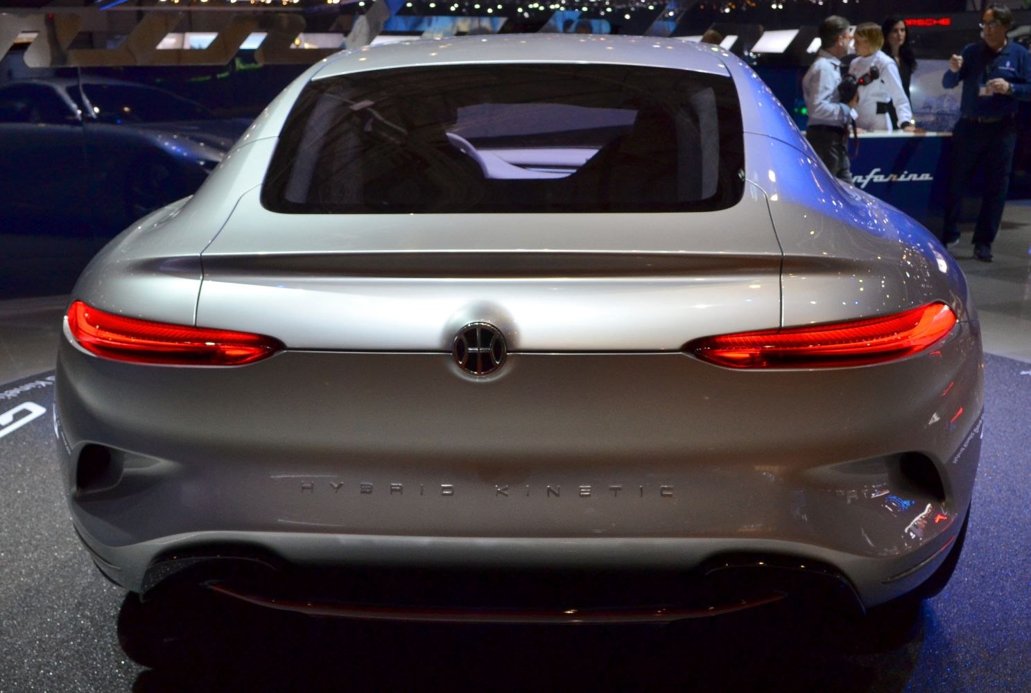Sleek car rear view with integrated rear lights and hybrid kinetic emblem
