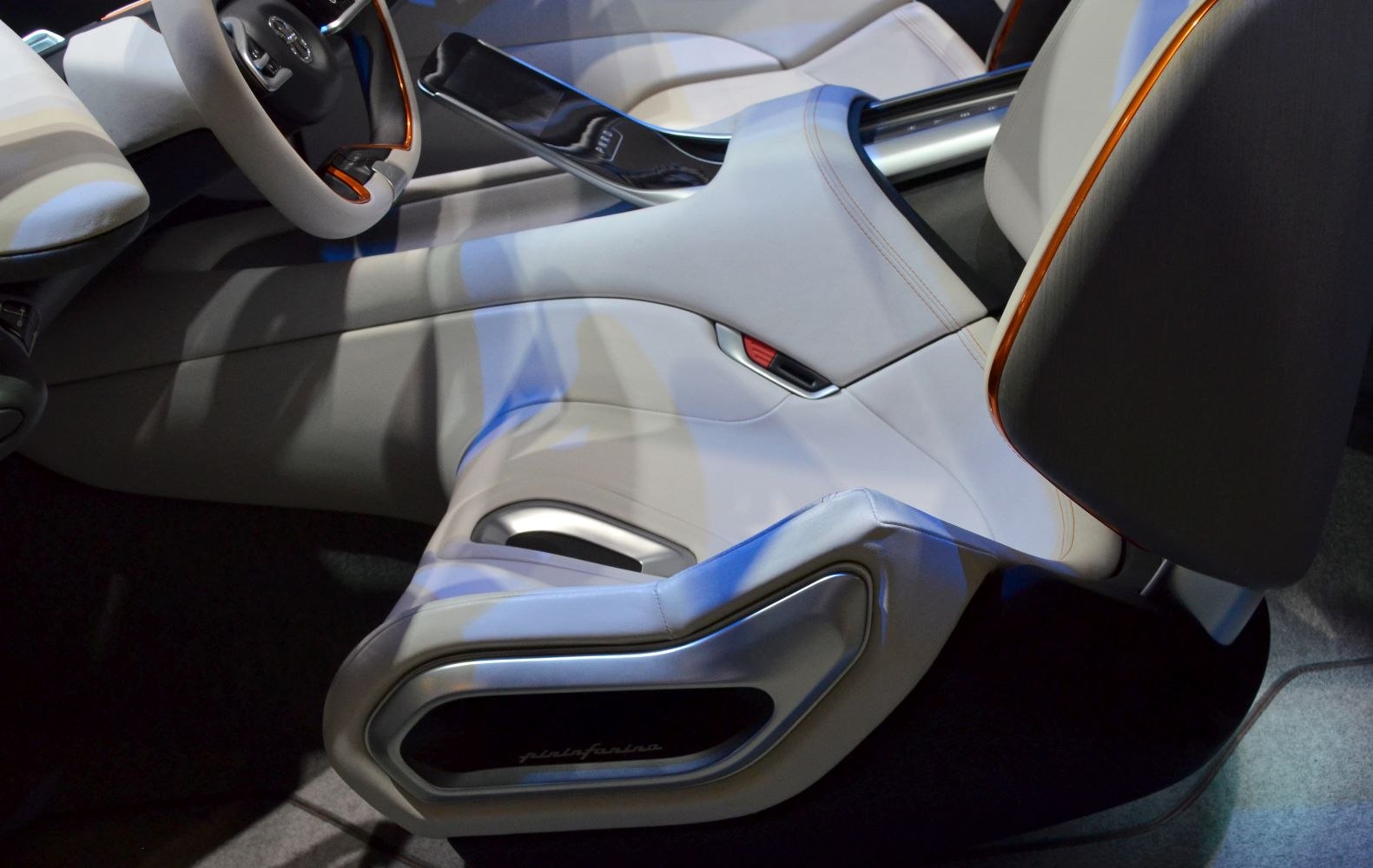 Futuristic car interior with sleek steering wheel and modern seating