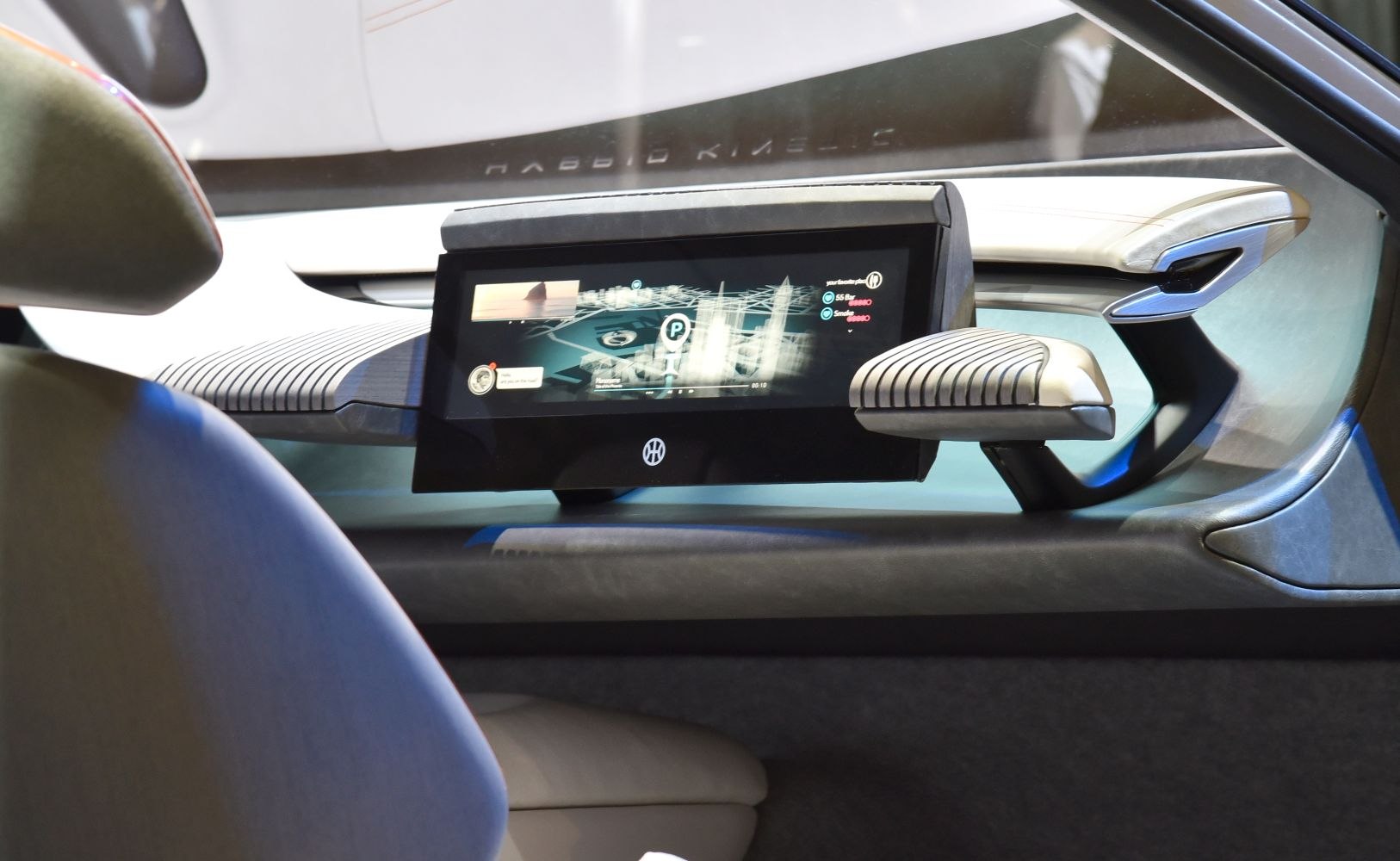 Futuristic digital dashboard display with unique armrest design.