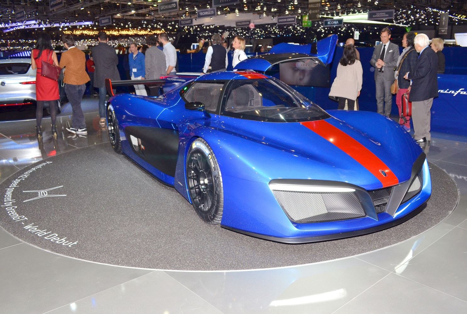 Blue aerodynamic race car with red stripe and rear wing