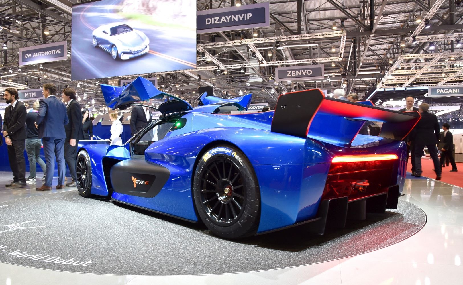 Blue supercar rear side with gullwing doors and large rear wing