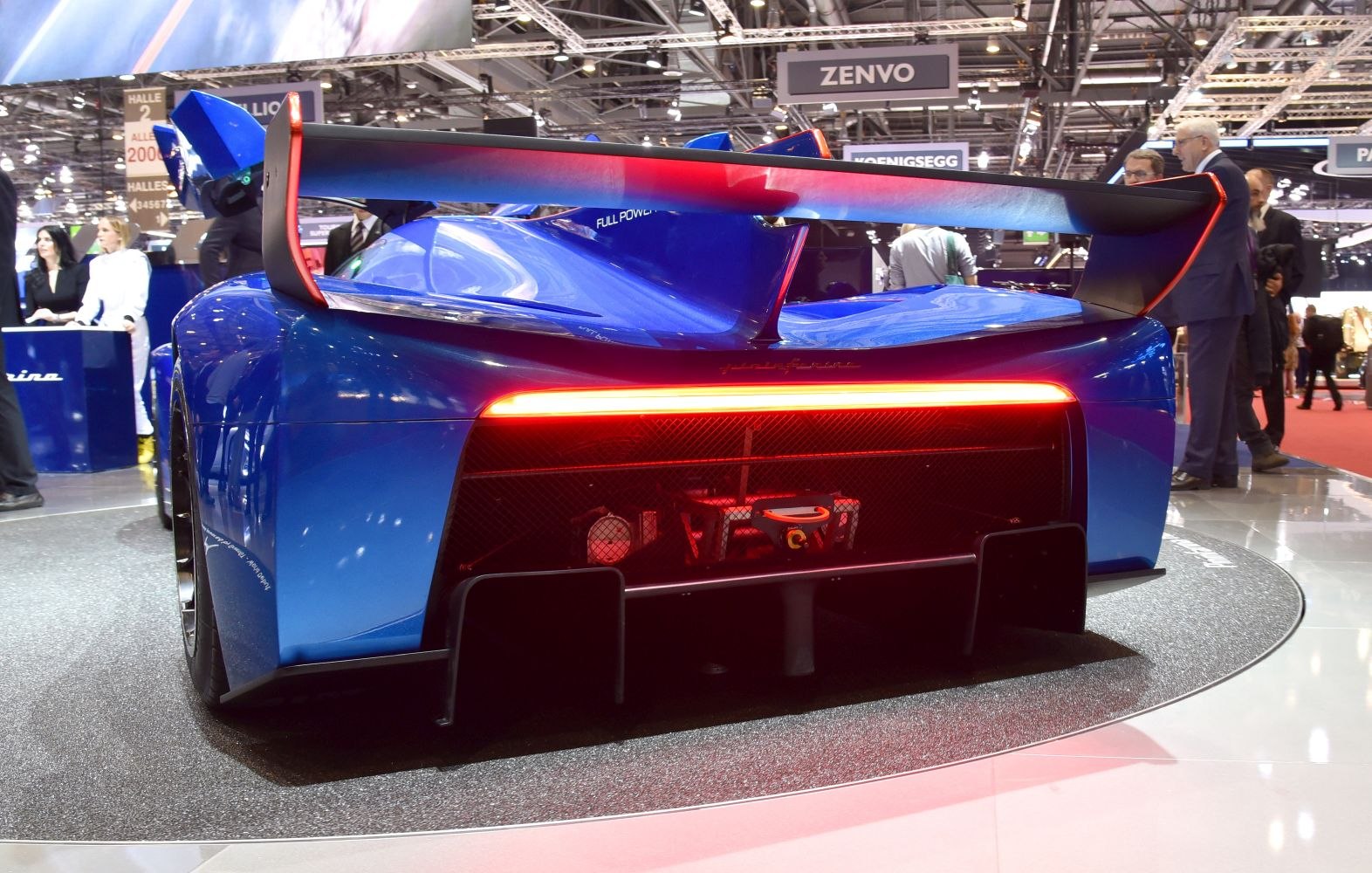 Active rear wing and LED continuous tail light on a blue high-performance vehicle rear view