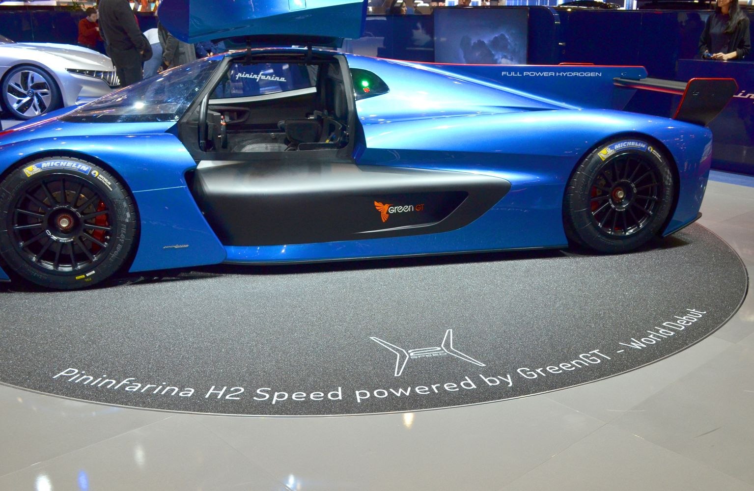 Side profile of hydrogen-powered race car with gullwing door and aerodynamic body