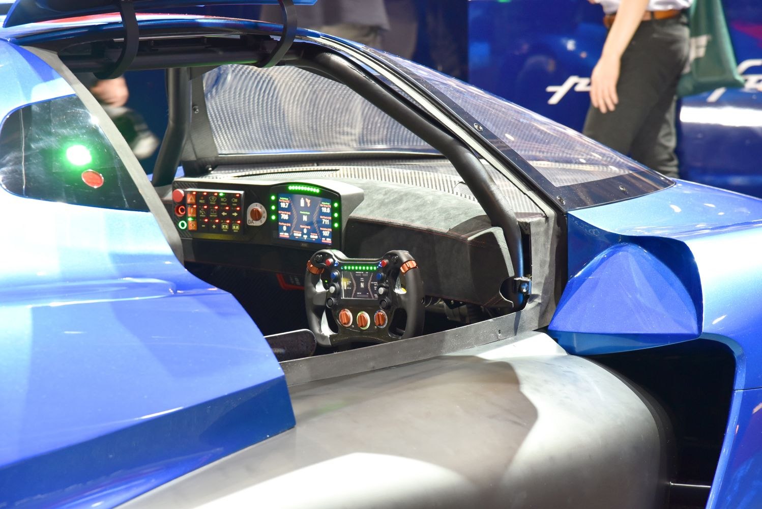 Racing cockpit with digital steering wheel and multiple digital displays