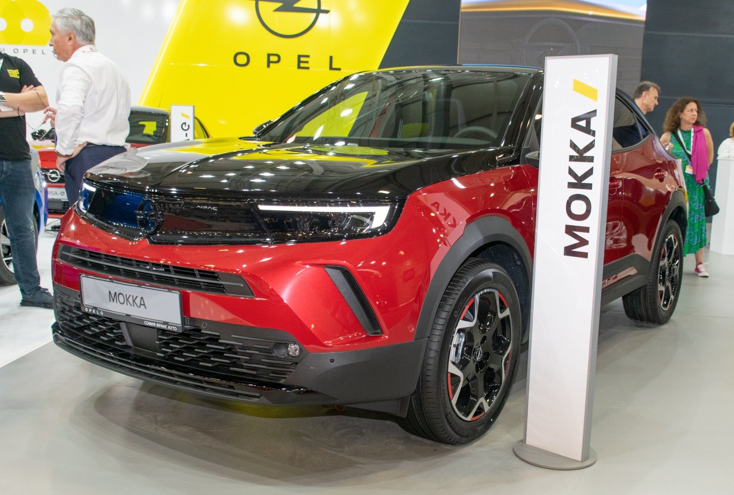 Front view of a two-tone black and red SUV with modern headlights