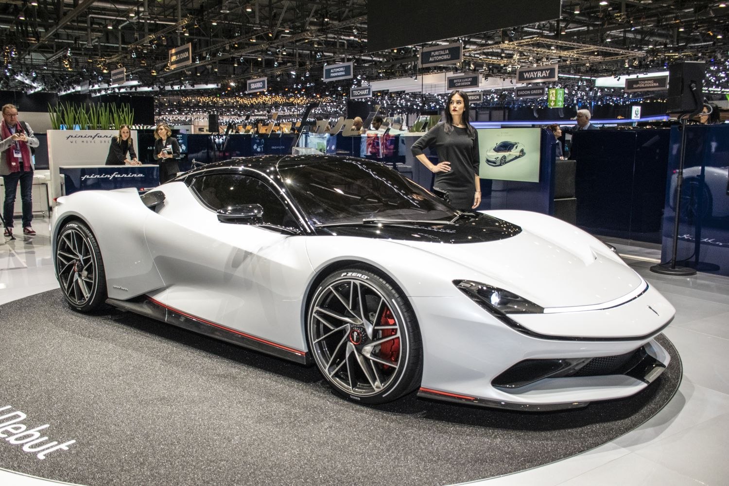White sports car with black roof and multi-spoke alloy wheels