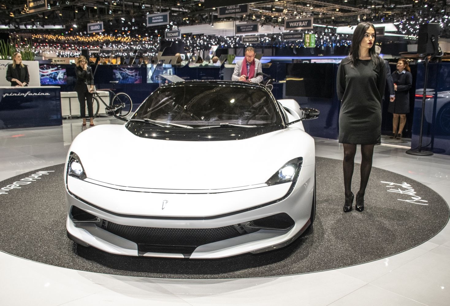 White electric hypercar with sleek headlights and aerodynamic front design
