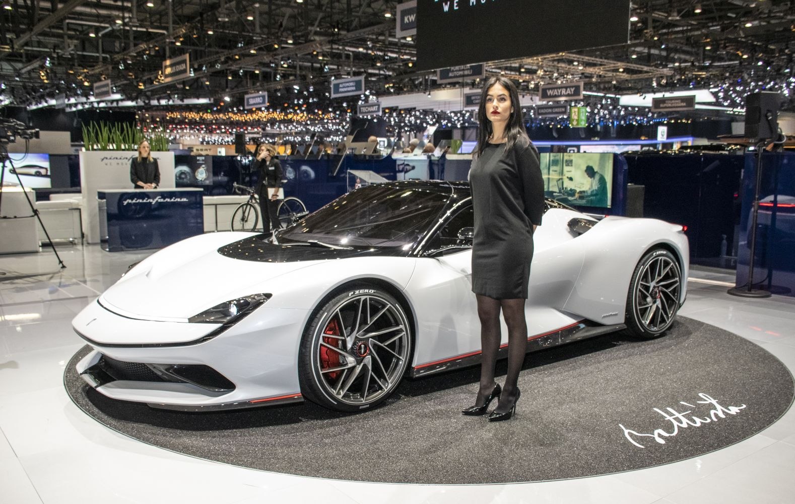White electric hypercar with aerodynamic design and large alloy wheels.