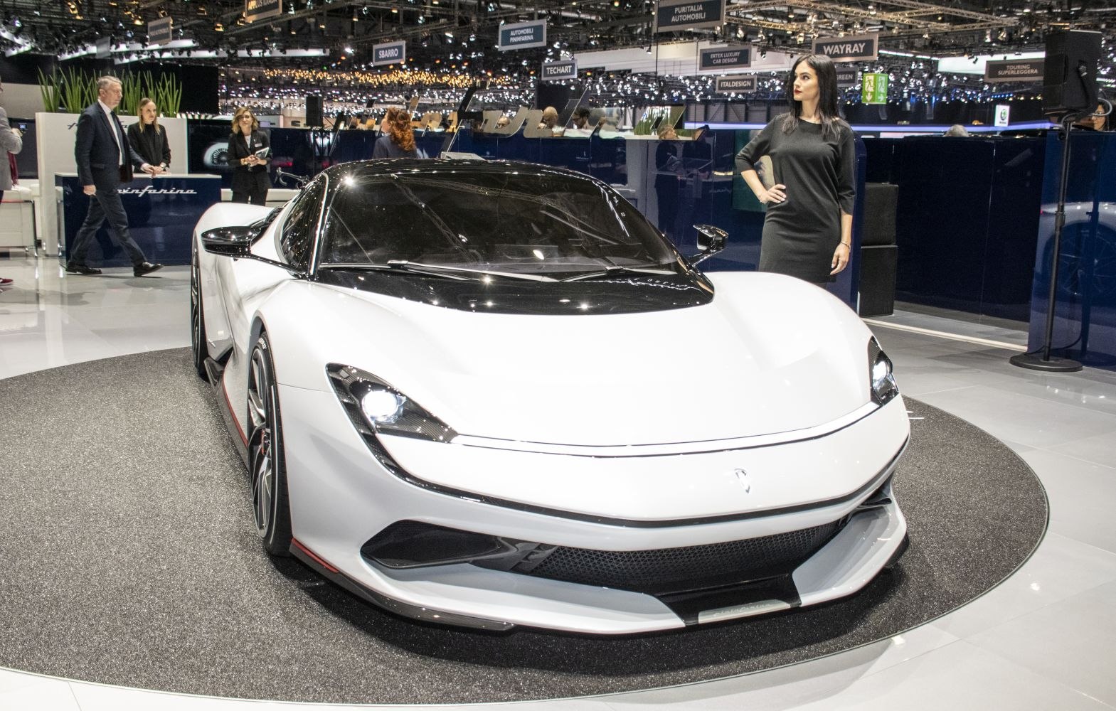 A sleek white electric hypercar front with aerodynamic design and sharp LED headlights