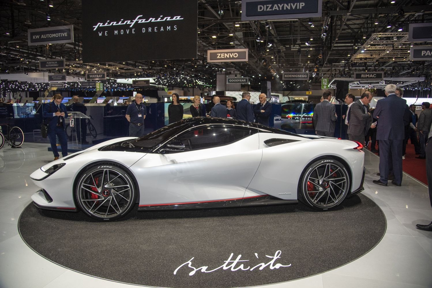 Side profile of white aerodynamic hypercar with alloy wheels