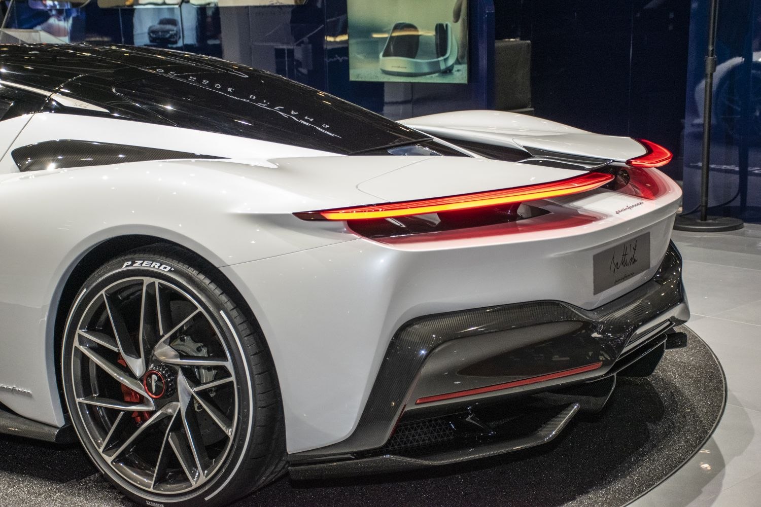 Rear LED light strip and alloy wheel close-up with carbon fiber diffuser