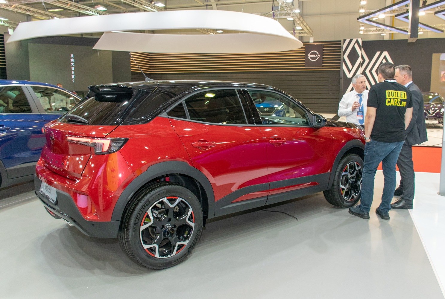Red crossover SUV with black roof and distinctive alloy wheels
