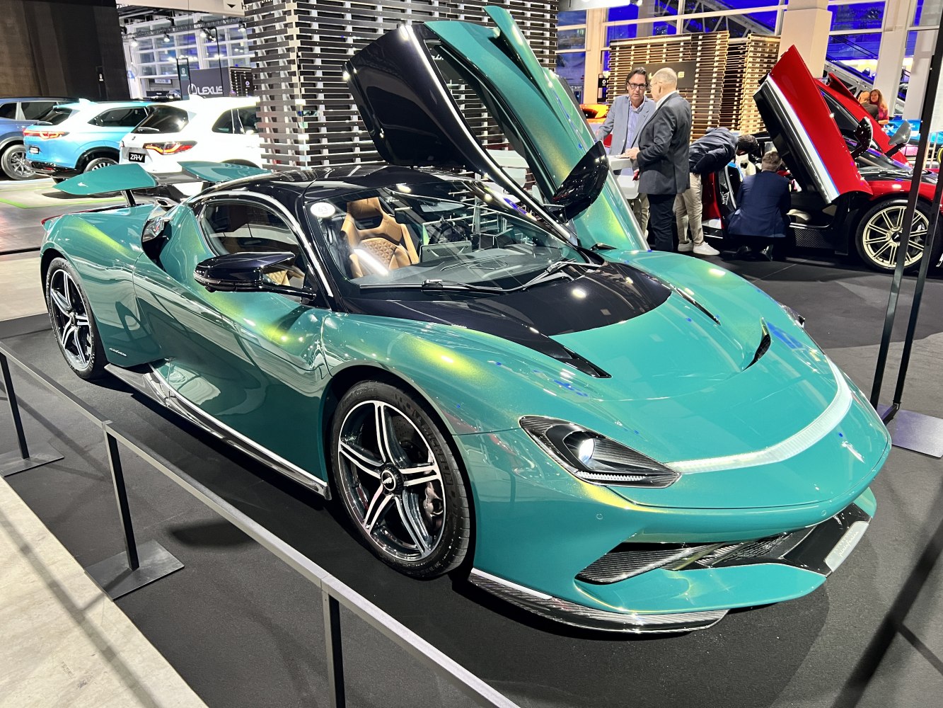Green hypercar with unique gullwing doors and sleek aerodynamic styling