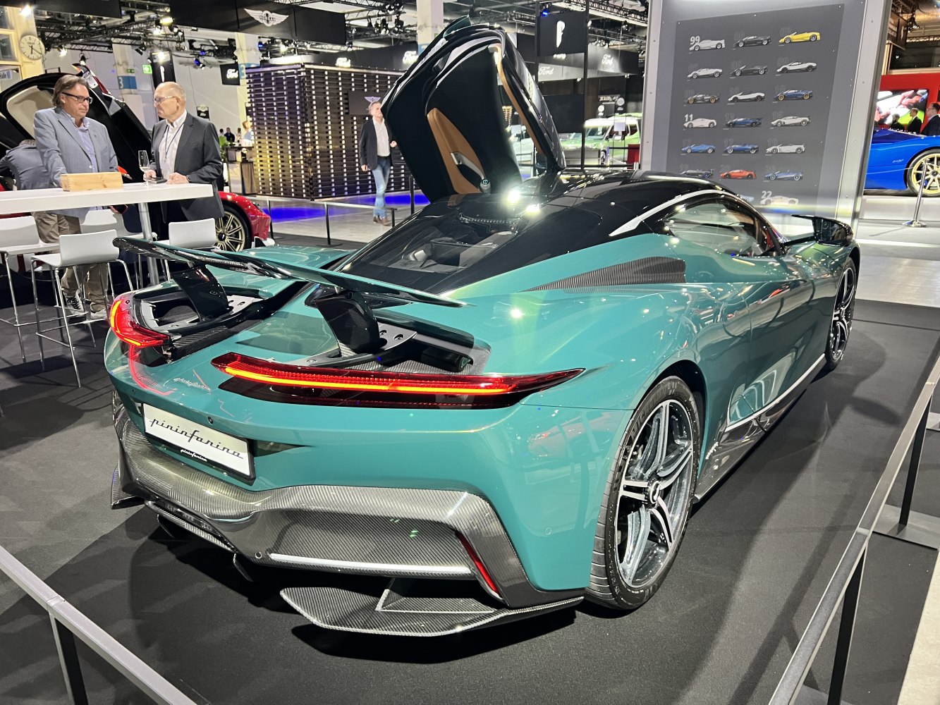 Active rear wing and carbon fiber rear diffuser on a sleek green sports coupe